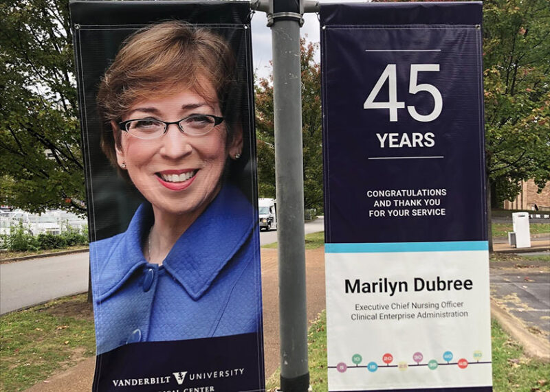 VUMC Exec Chief Nursing Officer Marilyn Dubree is pictured on vinyl banners outside the medical center, celebrating her 45 year service anniversary