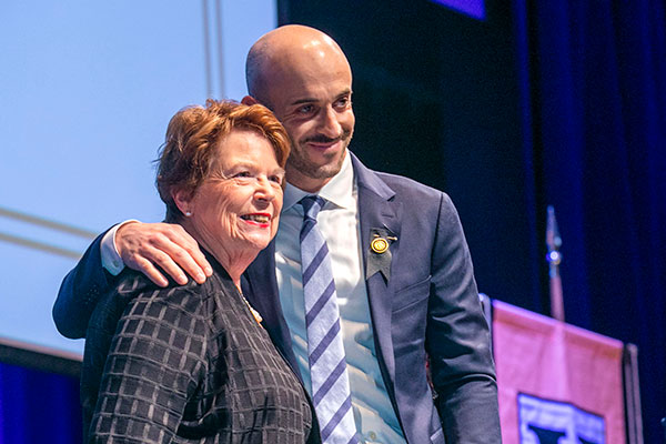 Dean Linda Norman hugged by FNP graduate Max Pollock