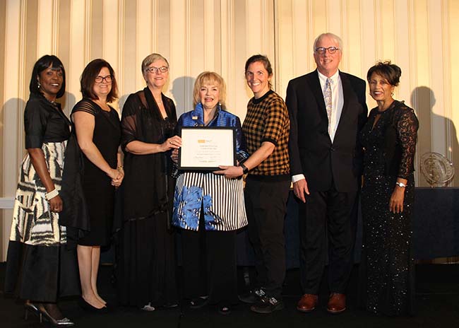 VUSN faculty with officials from National League of Nursing. Everyone is in formal dress.