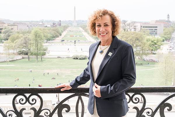 Dean Pam Jeffries standing on a balcony overlooking D.C.