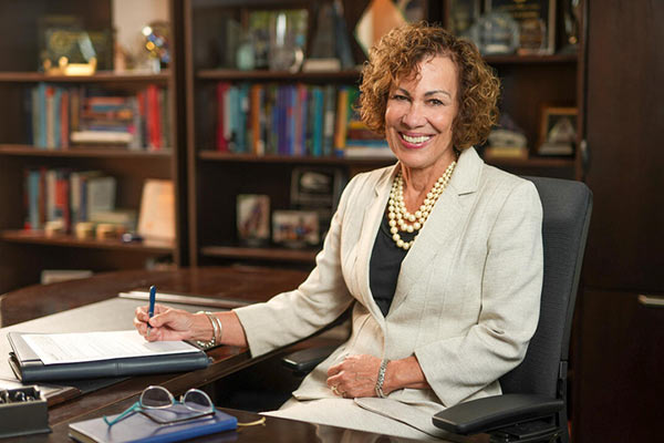 Dean Pam Jeffries at her desk writing