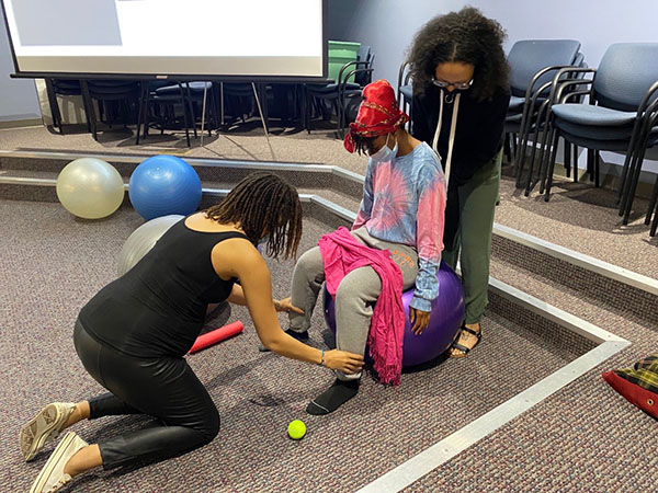 three people work on doula training