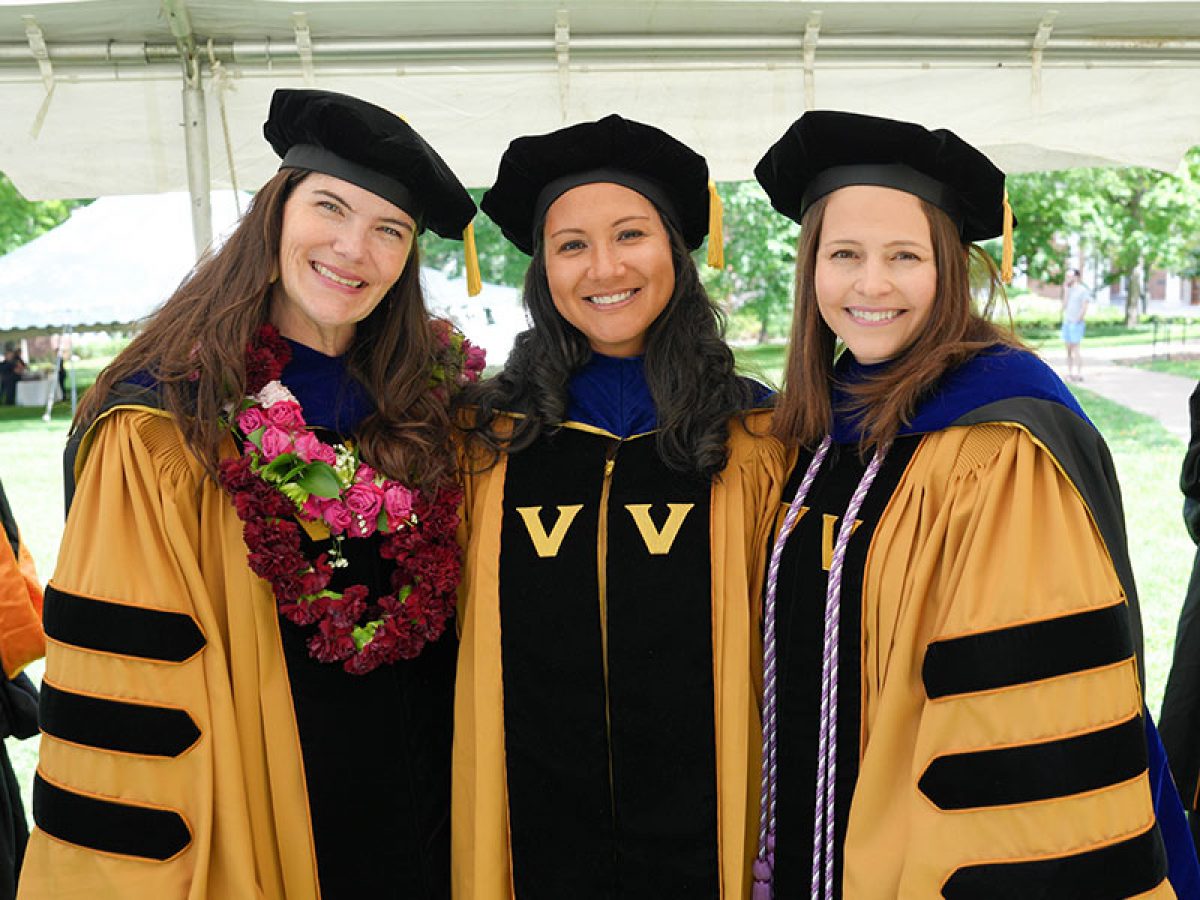 Three PhD graduates in regalia