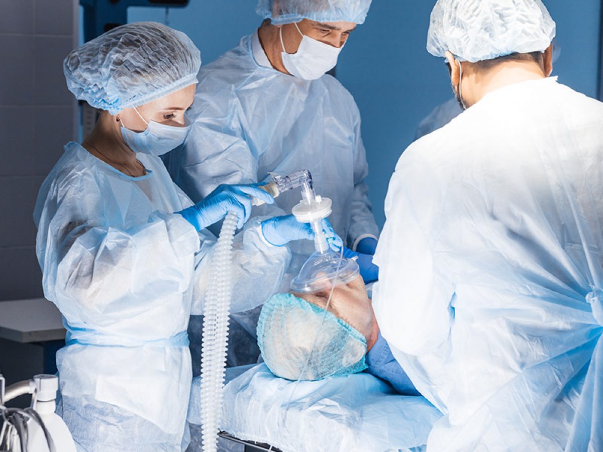 a nurse anesthetist adminstering anesthesia to a patient during an operation