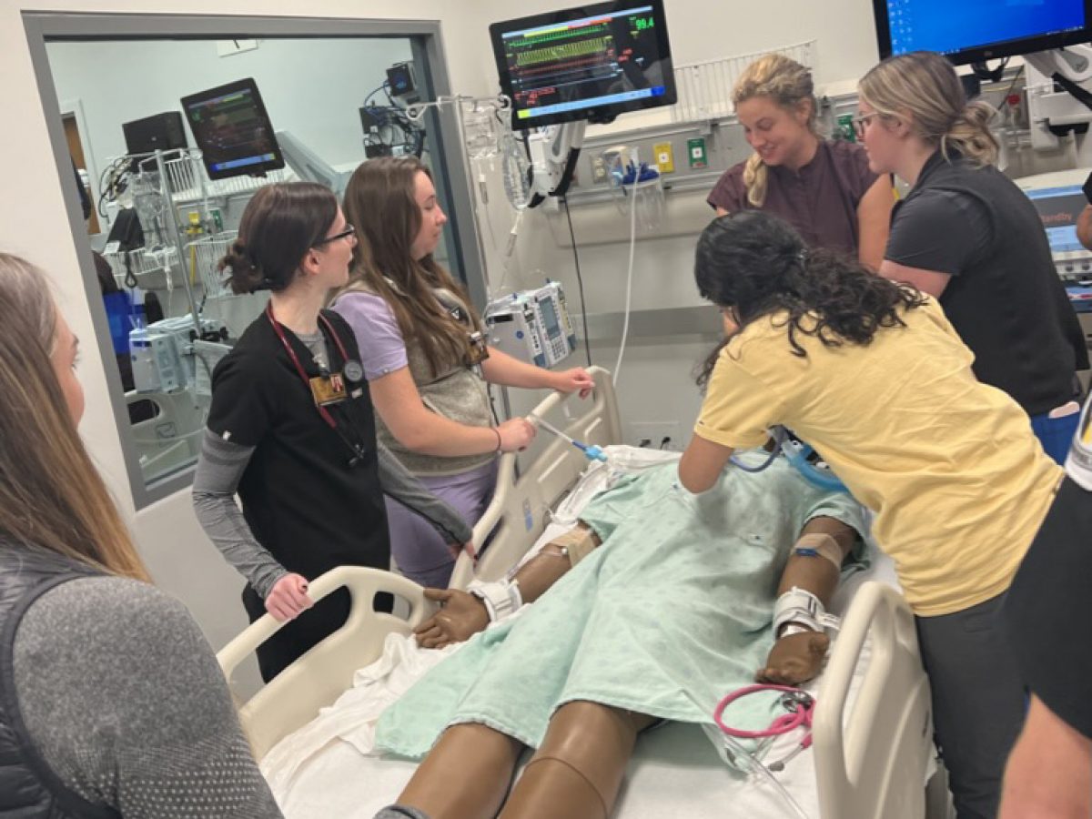 Nursing student cares for a trauma patient in a simulation