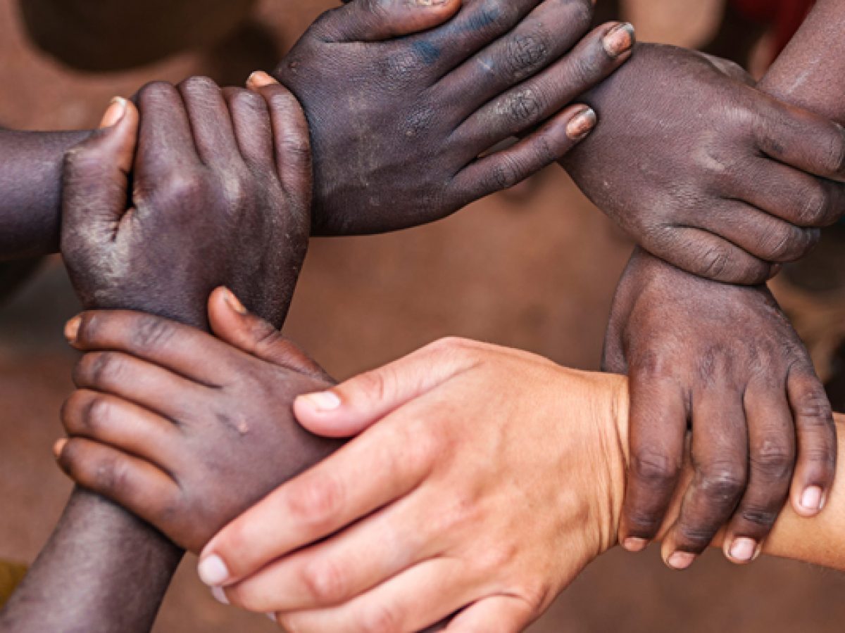 hands holding one another in a circle