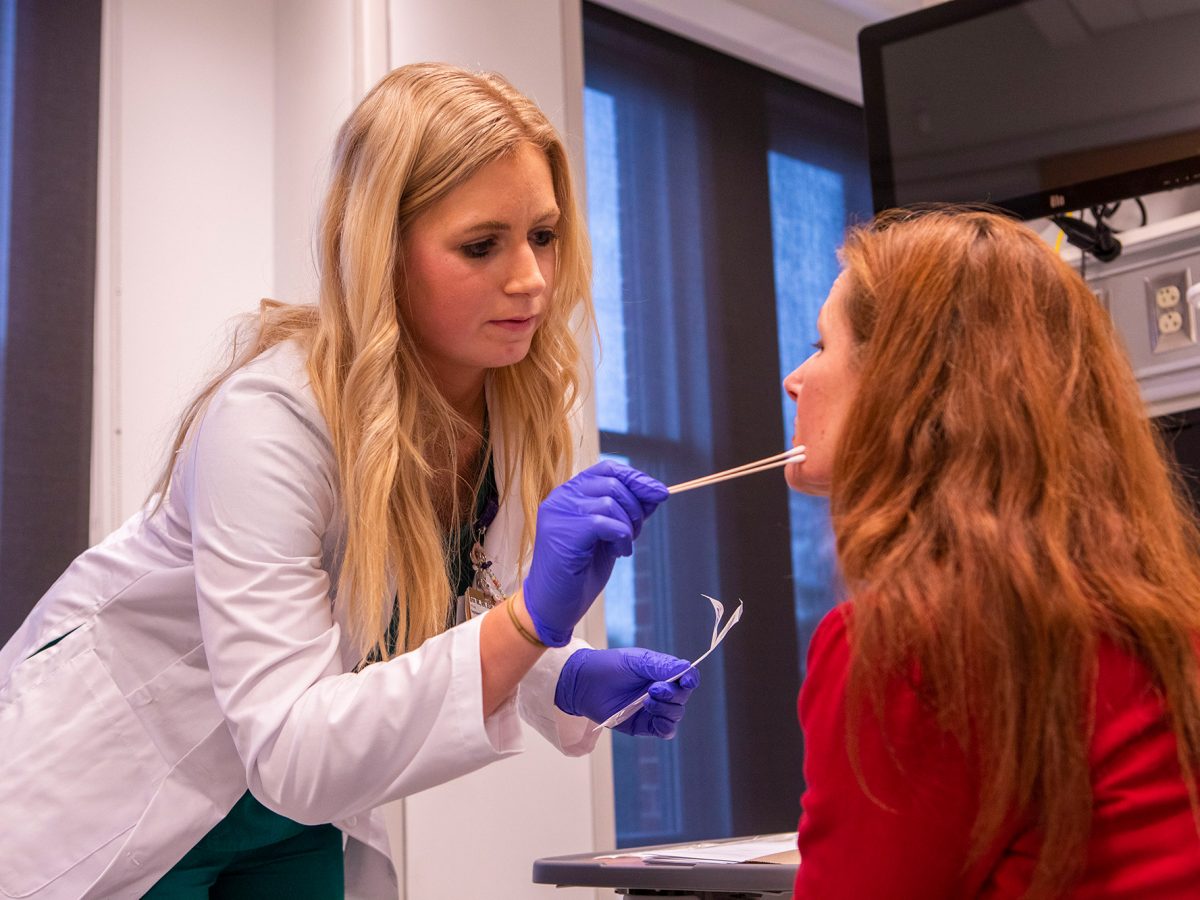 nurse swabbing a patient's cheek