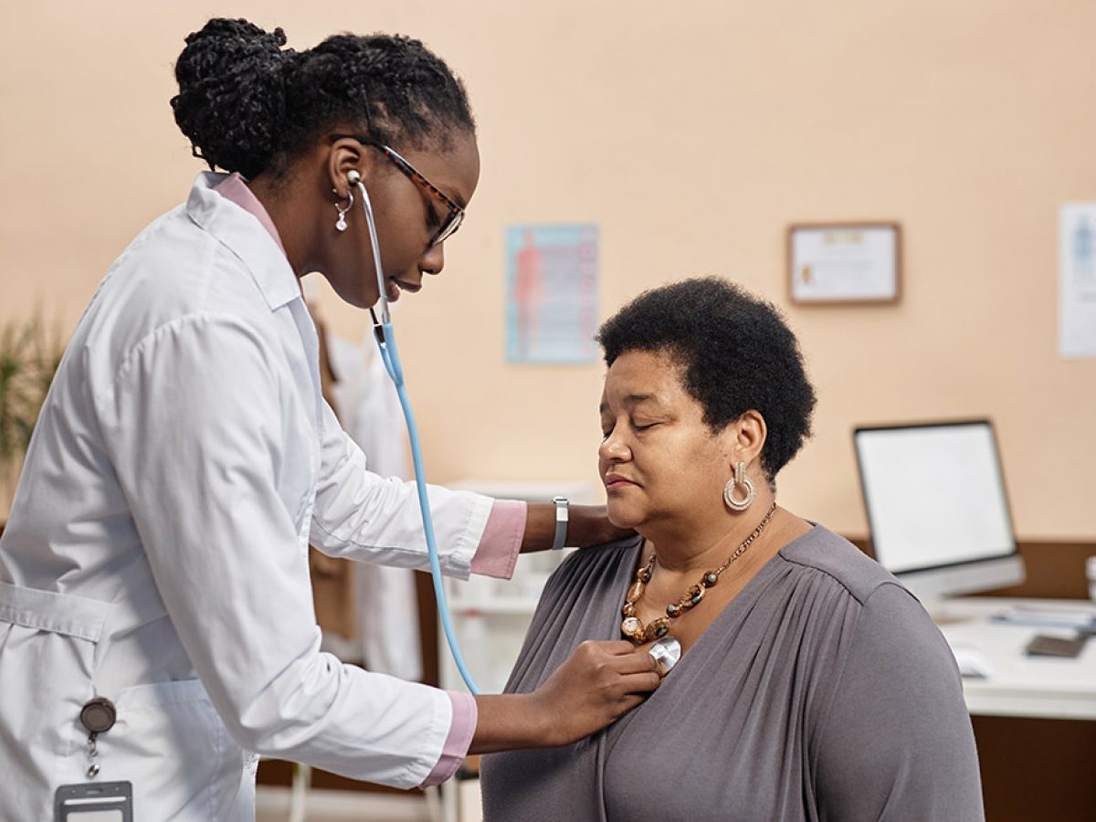 nurse listening to a patient's heart